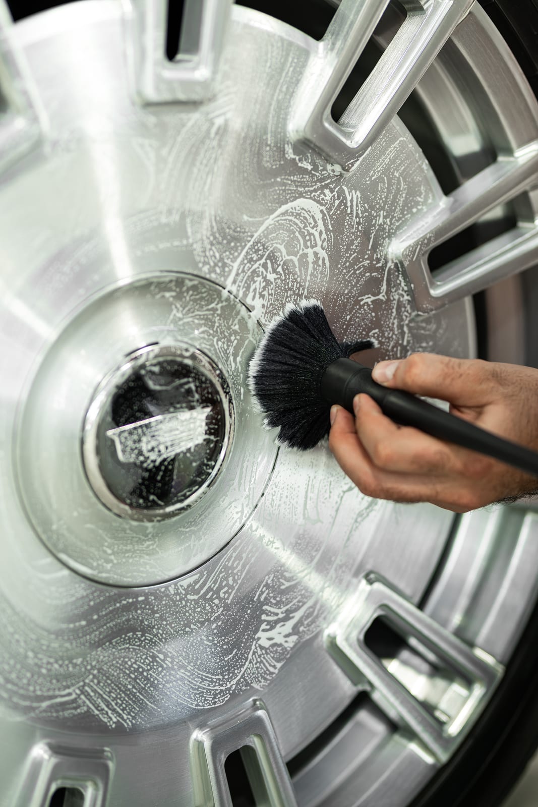 Detailer cleaning a Cadillac Escalade wheel at WRPD in Chatsworth