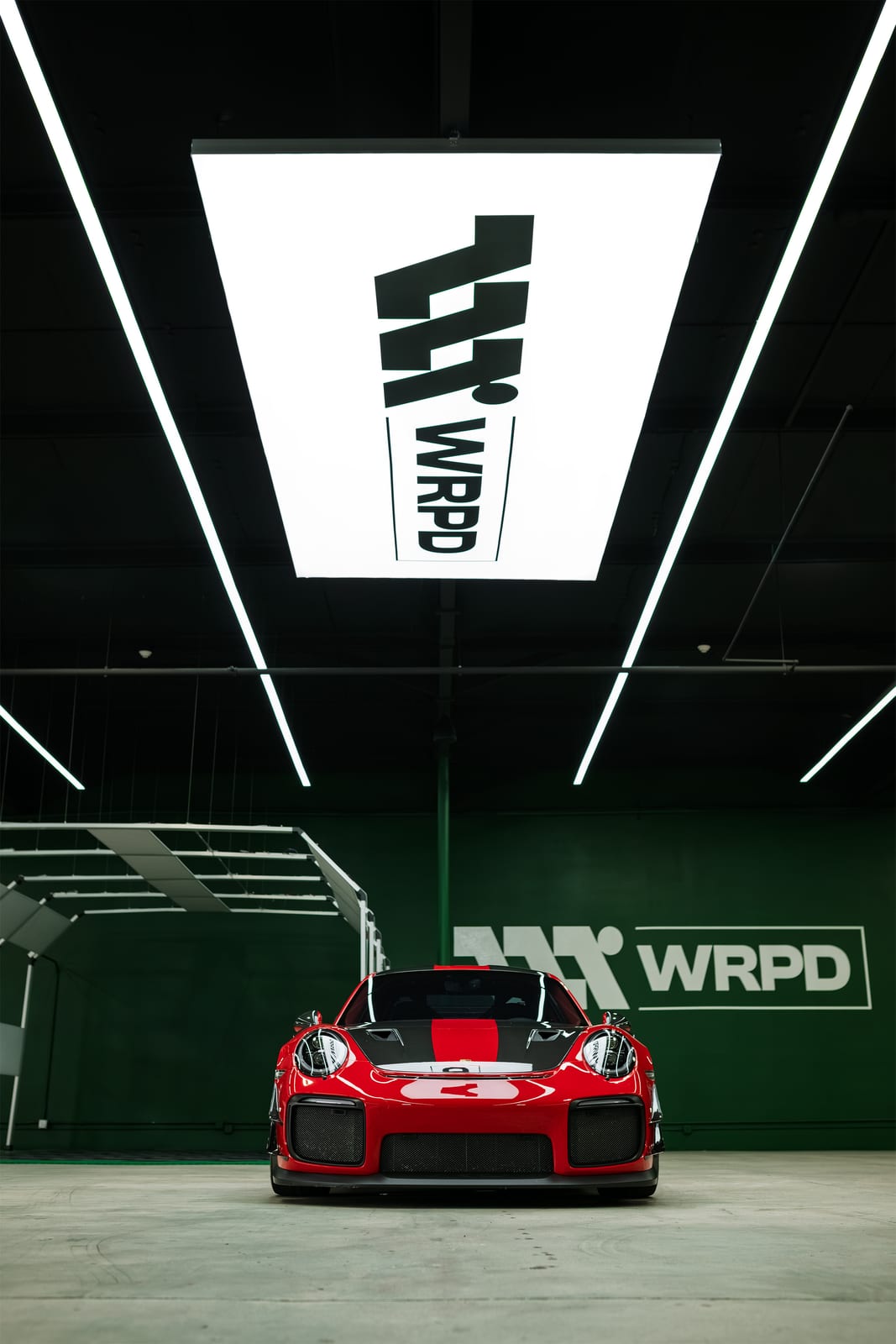 Red Porsche 911 GT2 RS under the WRPD lightbox in Chatsworth